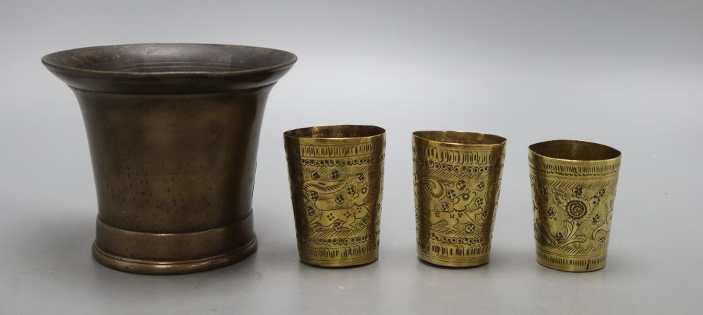 A 19th century bronze mortar and three small Persian measures